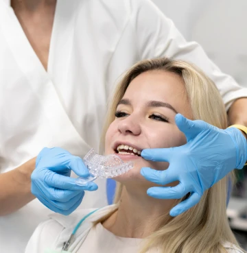 Orthodontist making teeth impression mold.